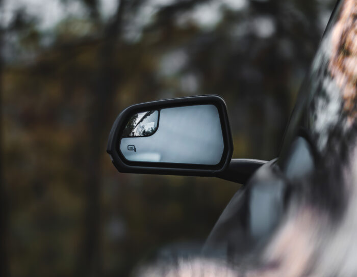 Car high technology side view mirror with blurred background